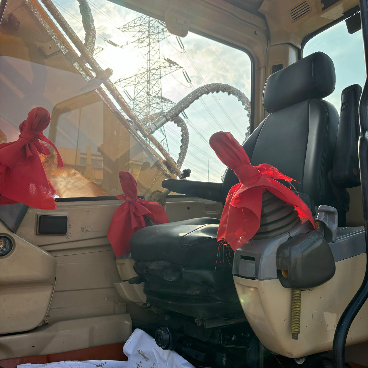 Clean operator cab interior with joysticks and seat in a used Cat 320 excavator